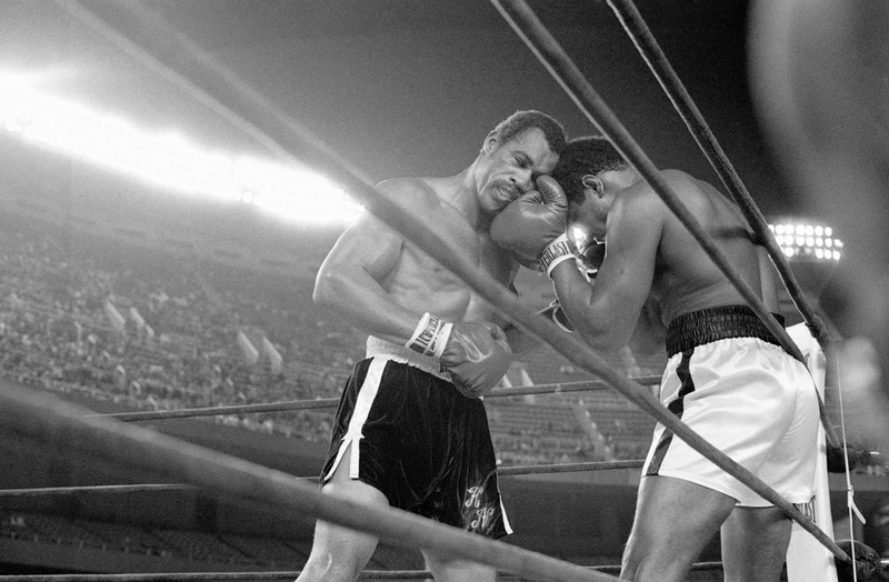 Norton leans on Ali against the ropes. Photo credit: AP